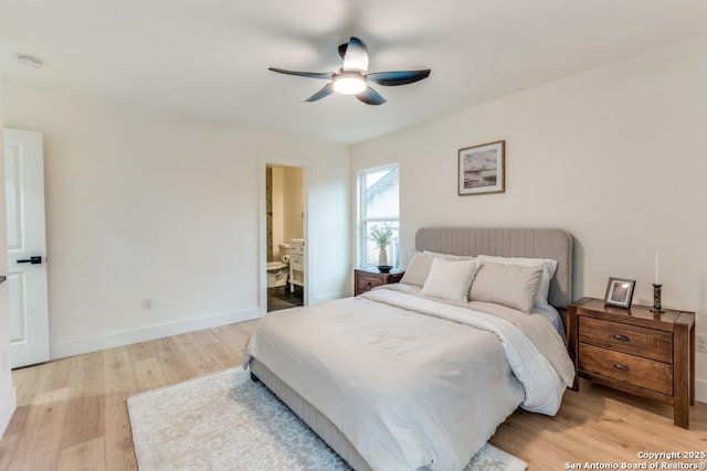 bedroom featuring ceiling fan, ensuite bathroom, and light hardwood / wood-style floors