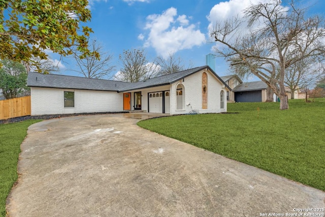 single story home with a garage and a front yard