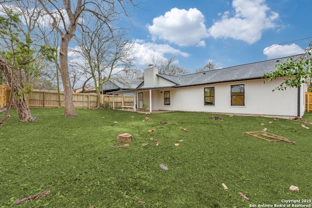 rear view of house featuring a lawn