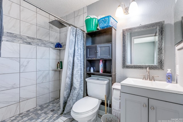 bathroom with walk in shower, vanity, toilet, and a textured ceiling