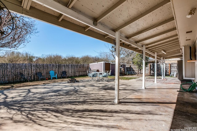 view of patio featuring a storage unit