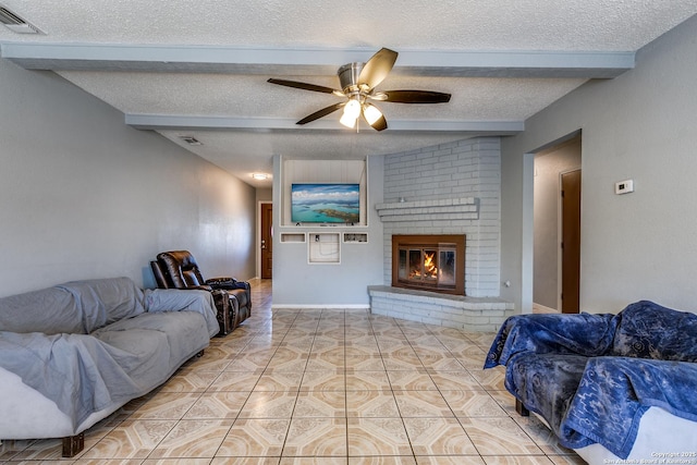 tiled living room with ceiling fan, a fireplace, lofted ceiling with beams, and a textured ceiling