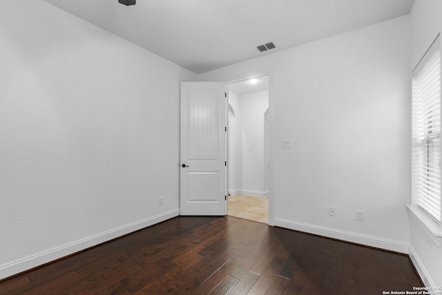 unfurnished room with dark hardwood / wood-style floors