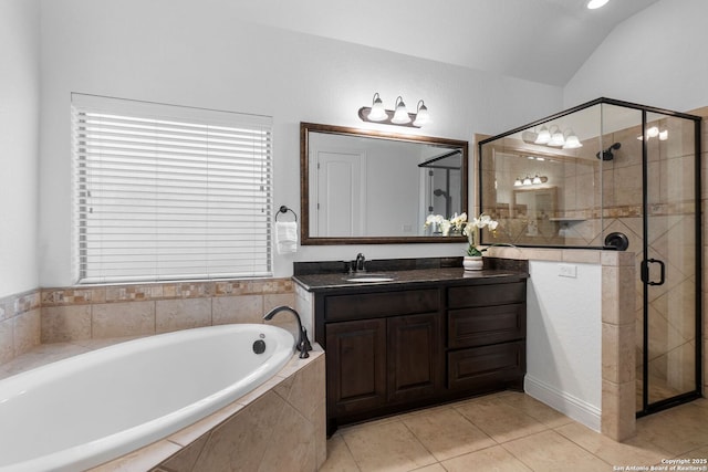 bathroom featuring vanity, tile patterned flooring, vaulted ceiling, and independent shower and bath