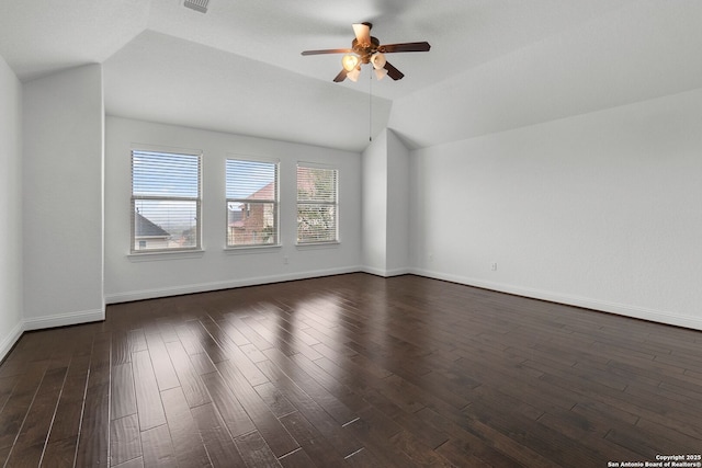 unfurnished room with lofted ceiling, dark hardwood / wood-style floors, and ceiling fan