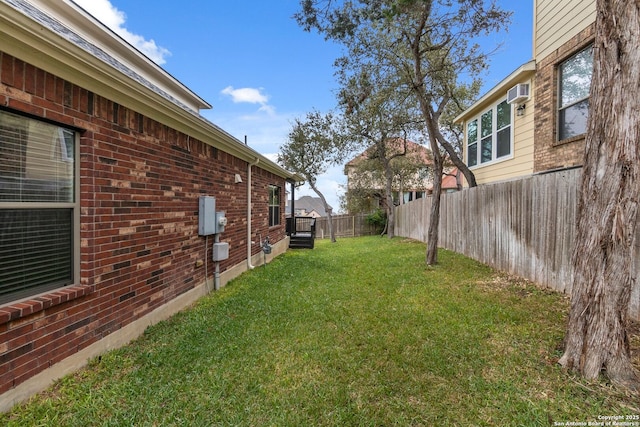 view of yard featuring a wall unit AC