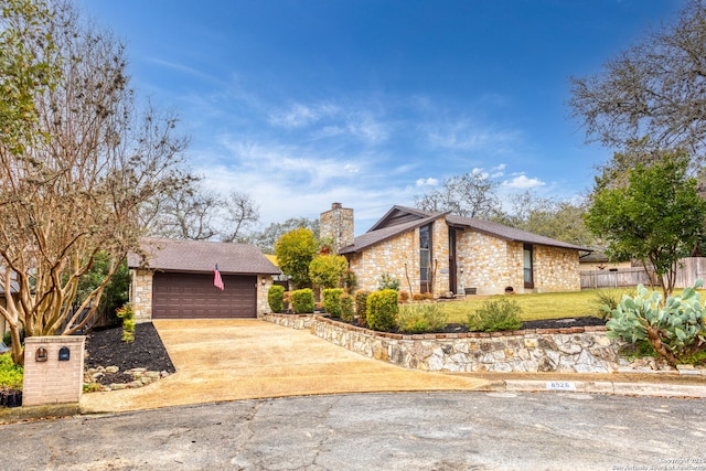 view of front of property with a garage and a front lawn