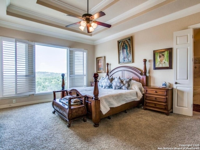 bedroom with crown molding, a tray ceiling, and ceiling fan