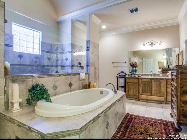 bathroom featuring vanity, ornamental molding, tile patterned floors, and tiled bath