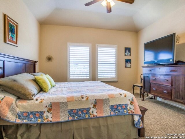 carpeted bedroom featuring ceiling fan and vaulted ceiling