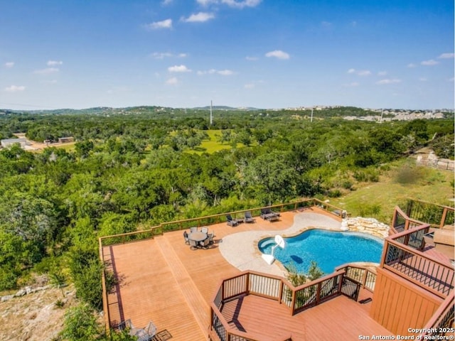 view of swimming pool featuring a patio and a deck