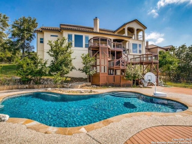 view of swimming pool featuring a deck