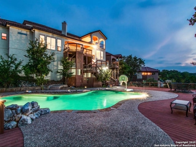 pool at dusk with a patio