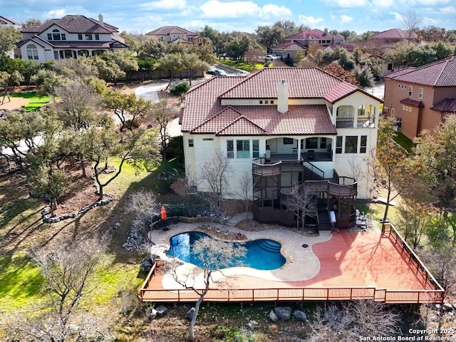 rear view of house with a patio and a balcony