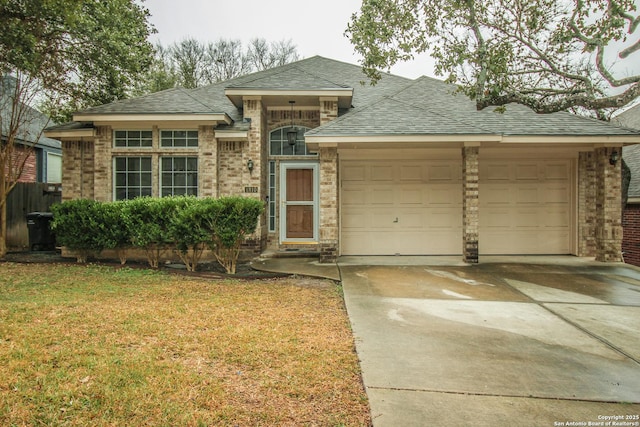 view of front of property with a garage and a front lawn