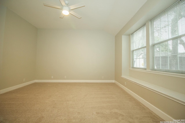 unfurnished room with ceiling fan, vaulted ceiling, and light carpet