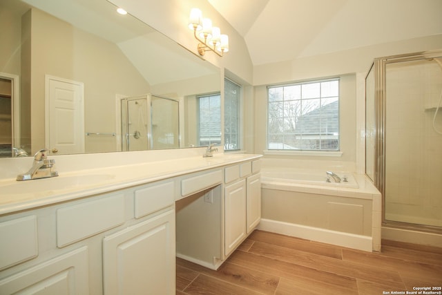 bathroom featuring lofted ceiling, vanity, and plus walk in shower