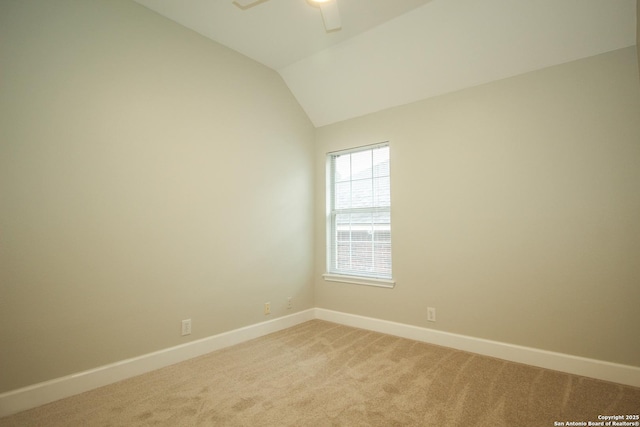 carpeted empty room with ceiling fan and vaulted ceiling