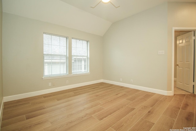 spare room with vaulted ceiling, ceiling fan, and light hardwood / wood-style floors