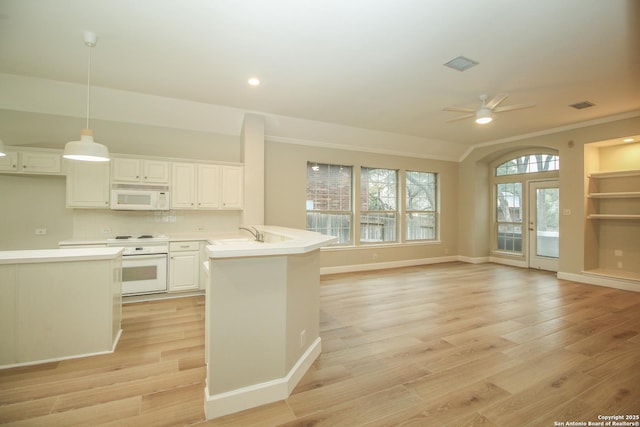 kitchen featuring white cabinetry, hanging light fixtures, ceiling fan, light hardwood / wood-style floors, and white appliances