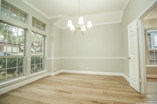 unfurnished room featuring ornamental molding, a notable chandelier, and light hardwood / wood-style flooring