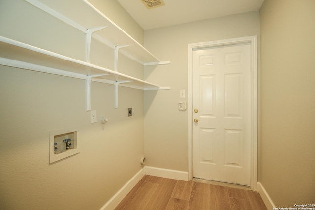 washroom with hookup for a gas dryer, wood-type flooring, washer hookup, and hookup for an electric dryer