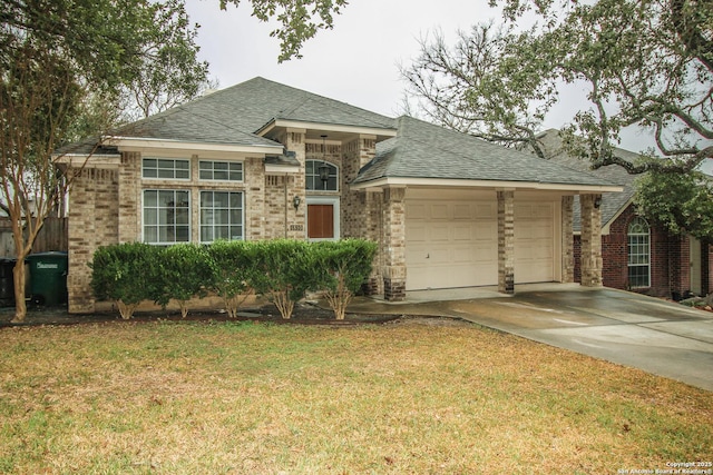 view of front of property with a garage and a front lawn