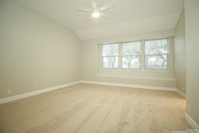 empty room with light carpet, vaulted ceiling, and ceiling fan