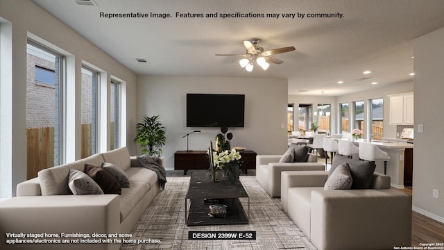 living room featuring hardwood / wood-style floors and ceiling fan