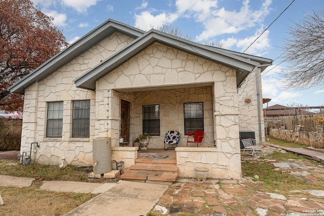 bungalow featuring central AC and a porch