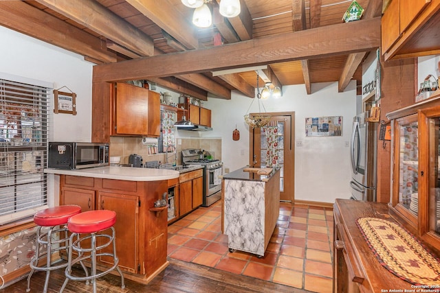 kitchen featuring tasteful backsplash, stainless steel appliances, sink, and a kitchen island