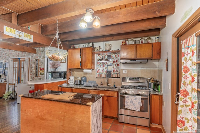 kitchen with sink, wooden ceiling, a kitchen island, stainless steel appliances, and beam ceiling