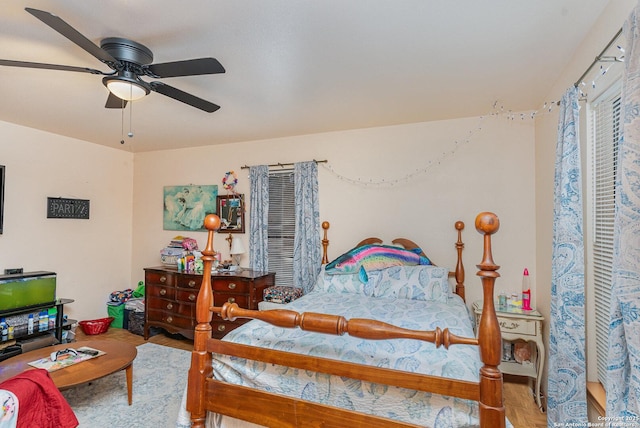 bedroom with hardwood / wood-style flooring and ceiling fan