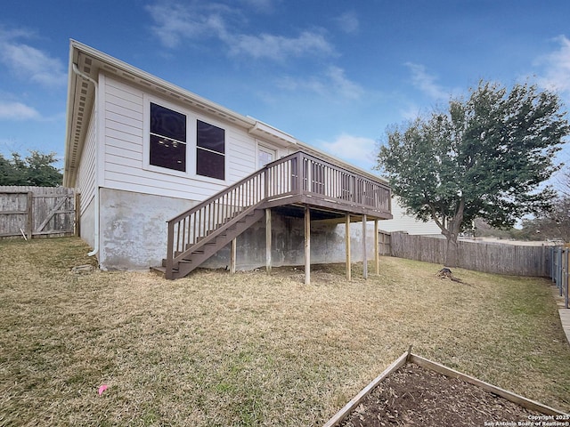 back of property featuring a yard and a deck