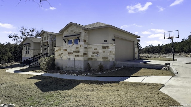 view of property exterior with an attached garage, stone siding, stairway, and concrete driveway