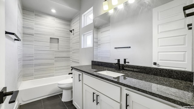 full bathroom with tiled shower / bath, tile patterned floors, toilet, and vanity