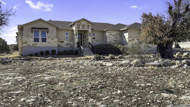 view of front of property featuring stone siding and stucco siding