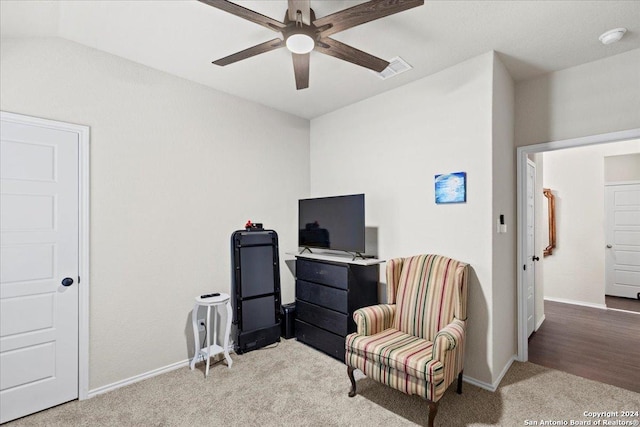 living area with light colored carpet and ceiling fan