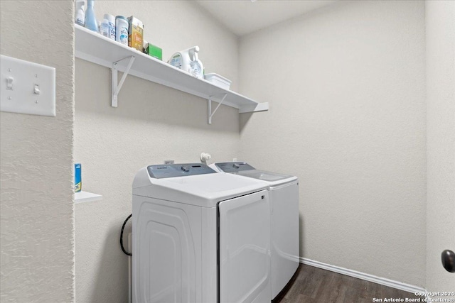 laundry area with dark hardwood / wood-style flooring and washing machine and clothes dryer