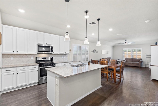 kitchen with appliances with stainless steel finishes, sink, and white cabinets