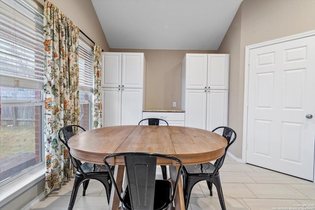 dining area featuring vaulted ceiling