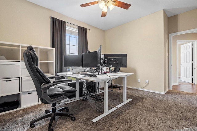 carpeted office space with ceiling fan