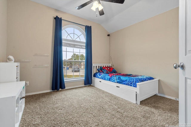 unfurnished bedroom with ceiling fan, carpet flooring, and vaulted ceiling