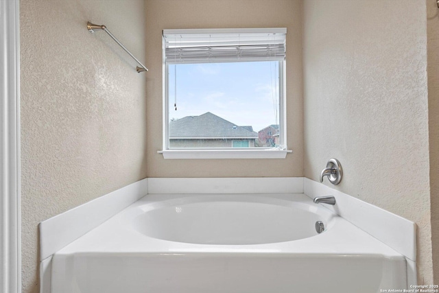 bathroom with a tub to relax in