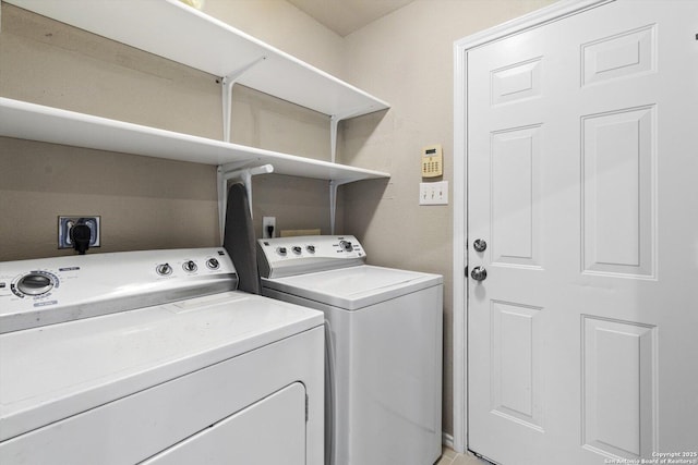 clothes washing area with washer and clothes dryer