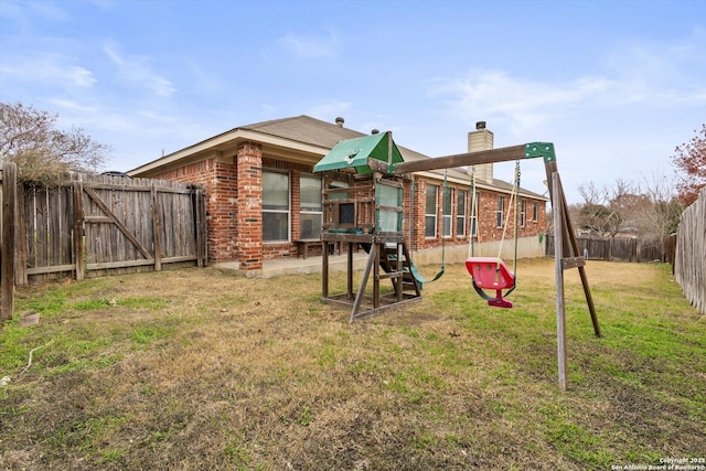 view of playground with a lawn