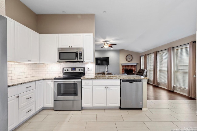 kitchen featuring appliances with stainless steel finishes, sink, and white cabinets