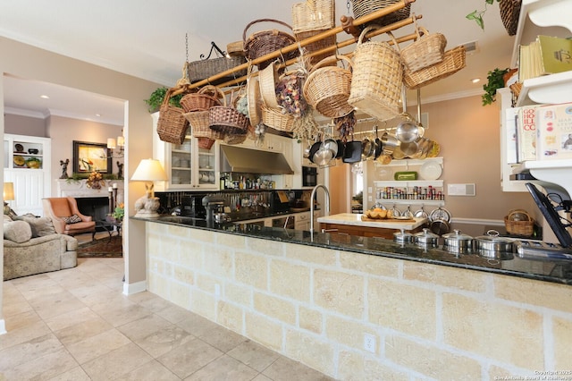 kitchen featuring crown molding, sink, and light tile patterned floors