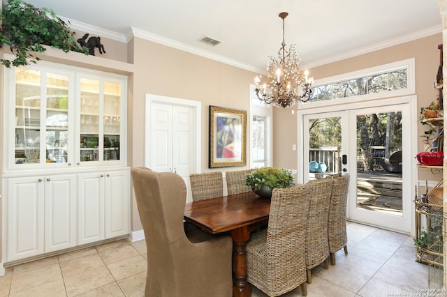 tiled dining room with crown molding, a notable chandelier, and french doors