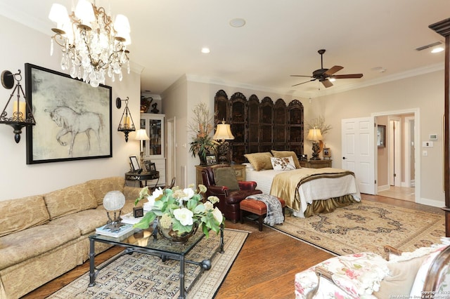 bedroom with ceiling fan with notable chandelier, ornamental molding, and hardwood / wood-style floors